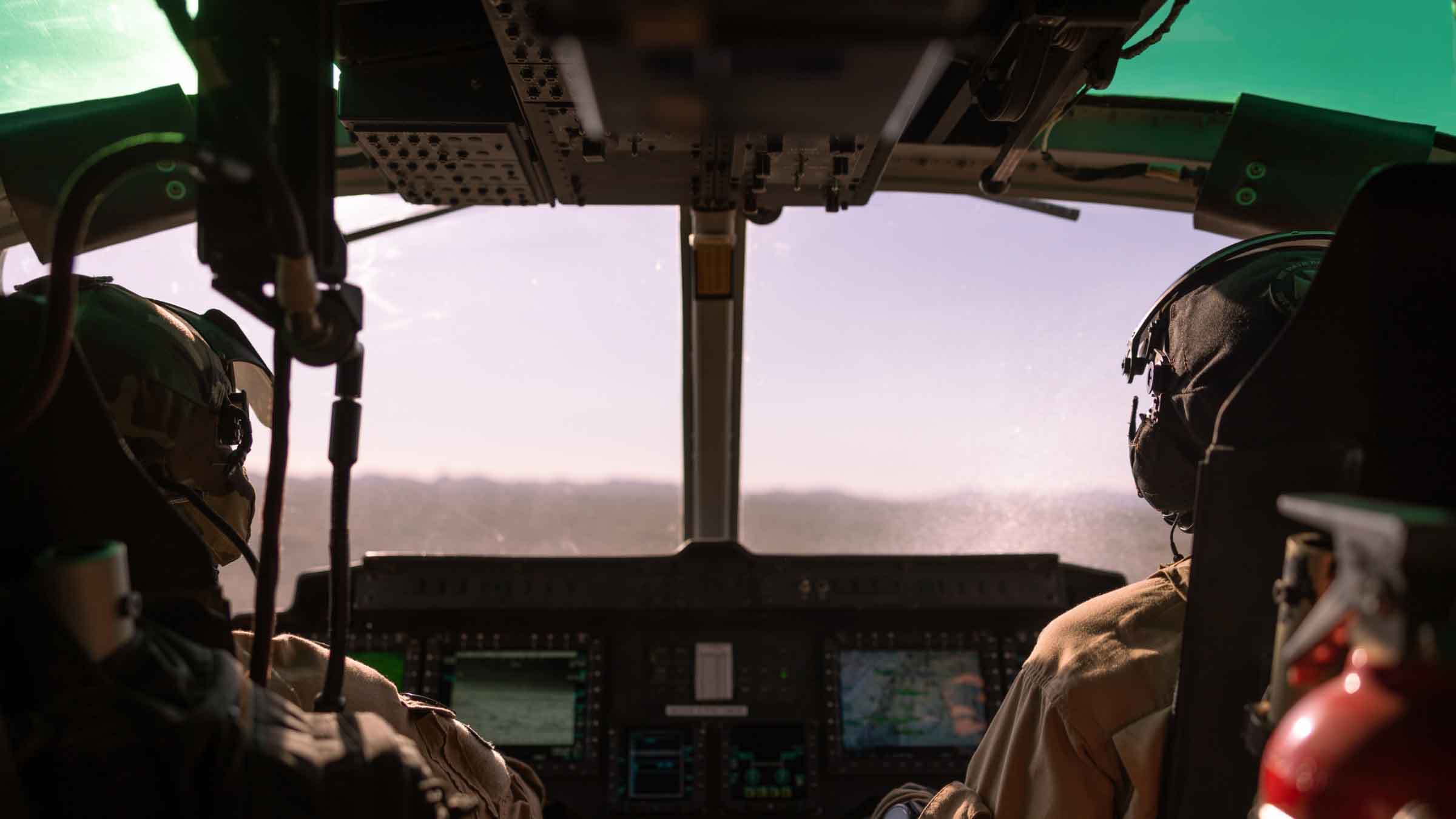 Two pilots in the cockpit of an aircraft, demonstrating By Light's simulation and training capabilities.