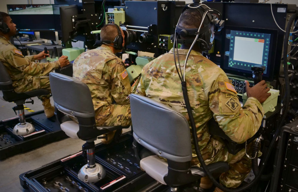 Military personnel operating high-fidelity reconfigurable collective trainers for training purposes.