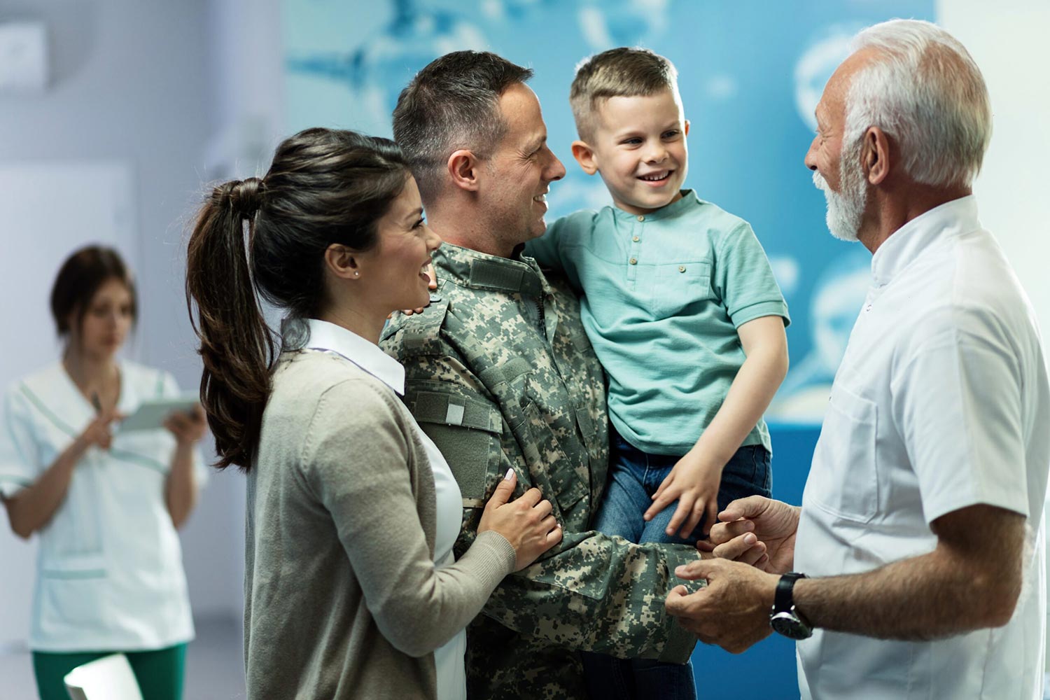 Happy military officer with his family communicating with doctor in the hospital.